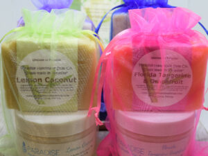 Handmade Soap and Lotion Gift sets on a table in colorful mesh bags, by Paradise Handmade Soap.